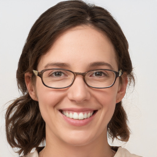 Joyful white adult female with medium  brown hair and blue eyes