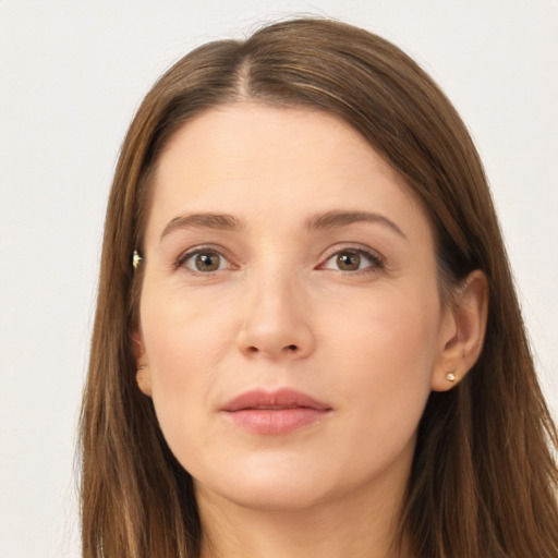 Joyful white young-adult female with long  brown hair and brown eyes