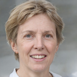 Joyful white adult female with short  brown hair and grey eyes