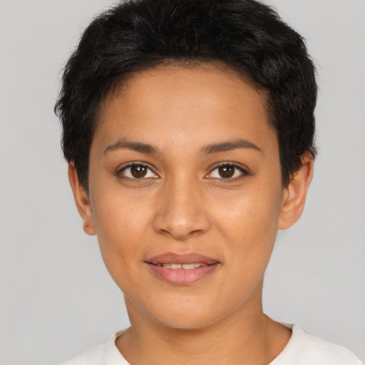 Joyful latino young-adult female with short  black hair and brown eyes