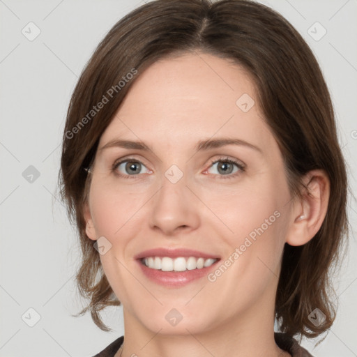 Joyful white young-adult female with medium  brown hair and grey eyes