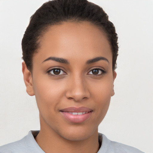 Joyful latino young-adult female with short  brown hair and brown eyes