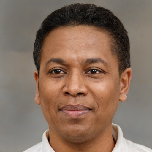 Joyful latino adult male with short  brown hair and brown eyes