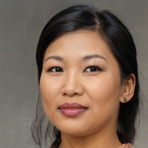 Joyful asian young-adult female with medium  black hair and brown eyes