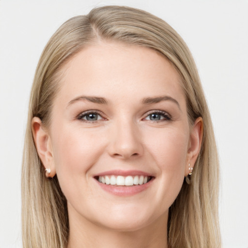 Joyful white young-adult female with long  brown hair and blue eyes