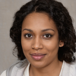 Joyful black young-adult female with medium  brown hair and brown eyes