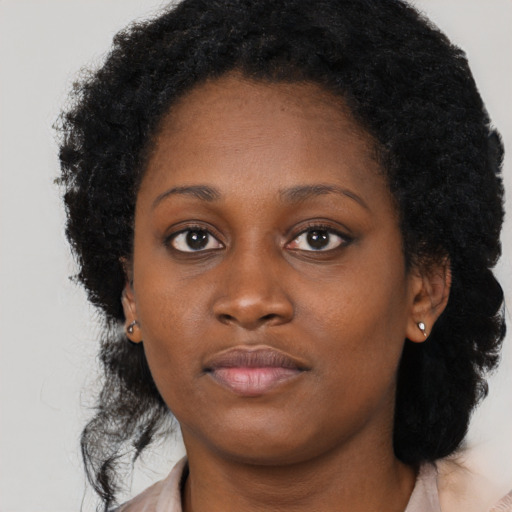 Neutral black young-adult female with long  brown hair and brown eyes
