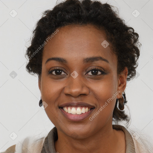 Joyful black young-adult female with long  brown hair and brown eyes