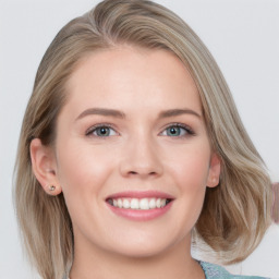 Joyful white young-adult female with medium  brown hair and blue eyes