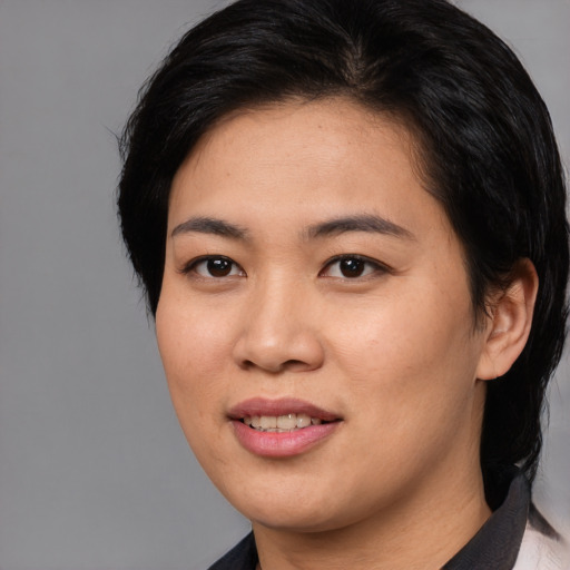 Joyful asian young-adult female with medium  black hair and brown eyes