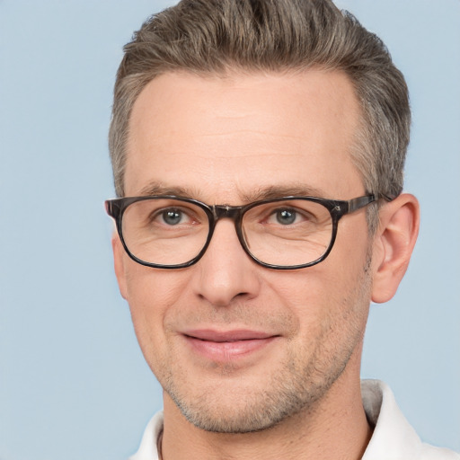 Joyful white adult male with short  brown hair and brown eyes