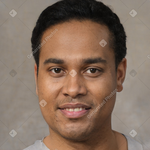 Joyful black young-adult male with short  black hair and brown eyes