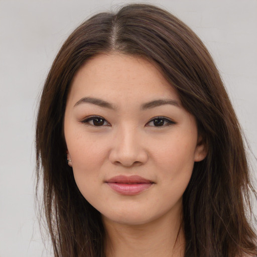 Joyful asian young-adult female with long  brown hair and brown eyes