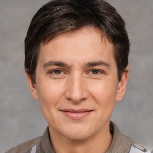 Joyful white adult male with short  brown hair and brown eyes