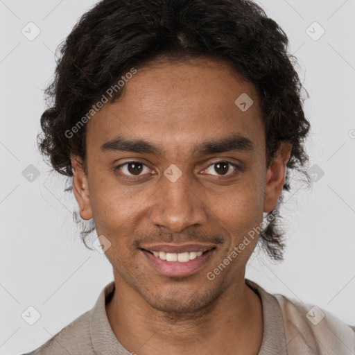 Joyful black young-adult male with short  brown hair and brown eyes