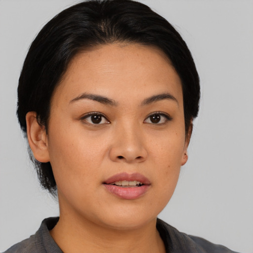 Joyful asian young-adult female with short  black hair and brown eyes