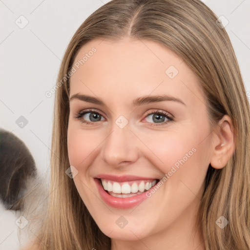 Joyful white young-adult female with long  brown hair and brown eyes