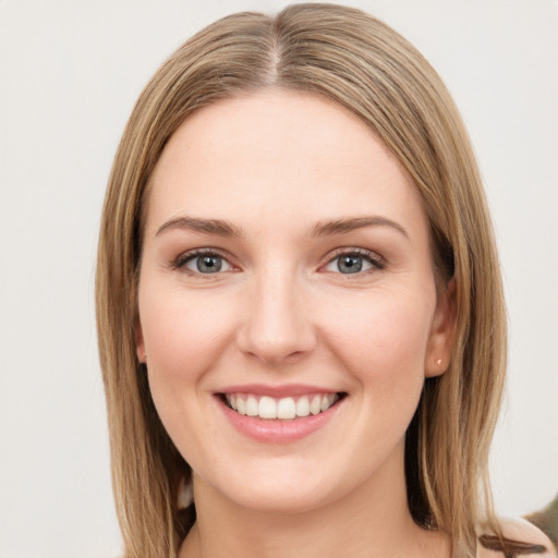 Joyful white young-adult female with long  brown hair and green eyes