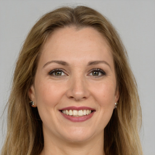 Joyful white young-adult female with long  brown hair and green eyes