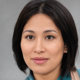 Joyful latino young-adult female with medium  brown hair and brown eyes