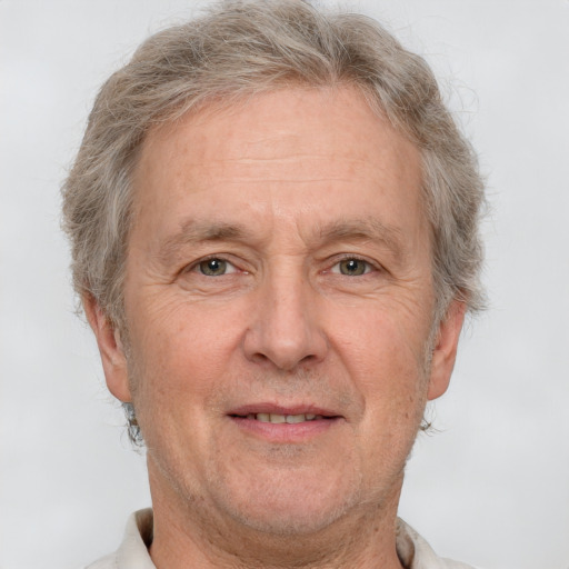 Joyful white middle-aged male with short  gray hair and brown eyes