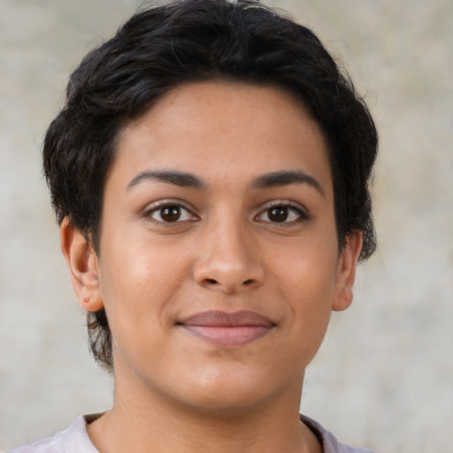 Joyful latino young-adult female with short  brown hair and brown eyes