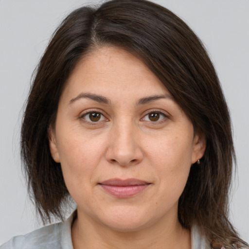 Joyful white adult female with medium  brown hair and brown eyes
