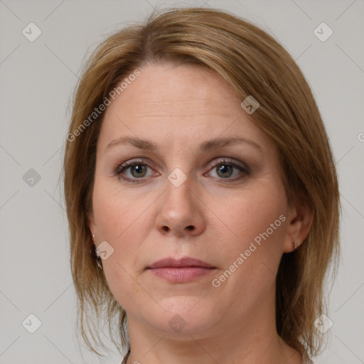 Joyful white adult female with medium  brown hair and grey eyes