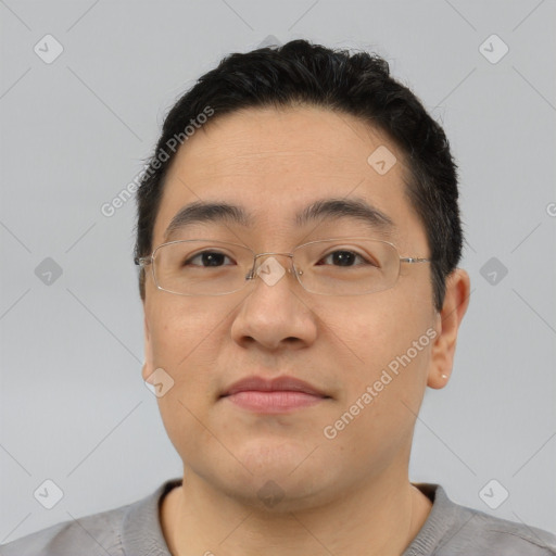 Joyful asian young-adult male with short  brown hair and brown eyes