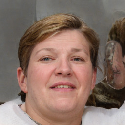 Joyful white adult female with medium  brown hair and blue eyes