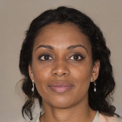 Joyful black young-adult female with medium  brown hair and brown eyes