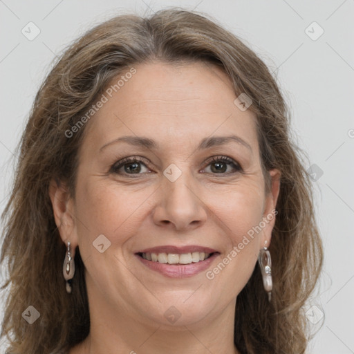 Joyful white adult female with long  brown hair and grey eyes