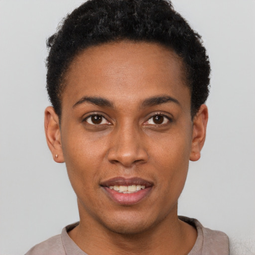 Joyful black young-adult female with short  black hair and brown eyes