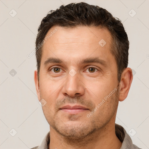 Joyful white adult male with short  brown hair and brown eyes