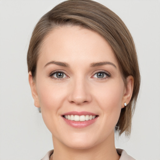 Joyful white young-adult female with medium  brown hair and grey eyes