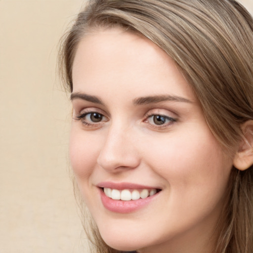 Joyful white young-adult female with long  brown hair and green eyes