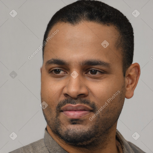 Joyful latino young-adult male with short  black hair and brown eyes