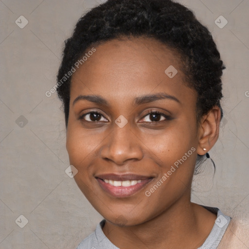 Joyful black young-adult female with short  black hair and brown eyes