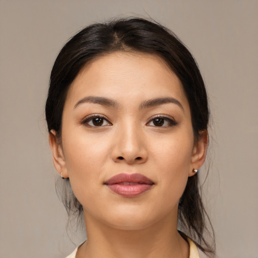 Joyful latino young-adult female with medium  brown hair and brown eyes