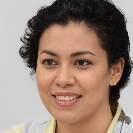 Joyful latino young-adult female with medium  brown hair and brown eyes