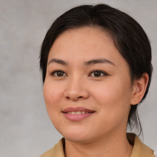 Joyful asian young-adult female with medium  brown hair and brown eyes