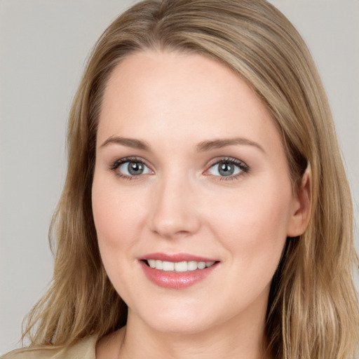 Joyful white young-adult female with long  brown hair and blue eyes