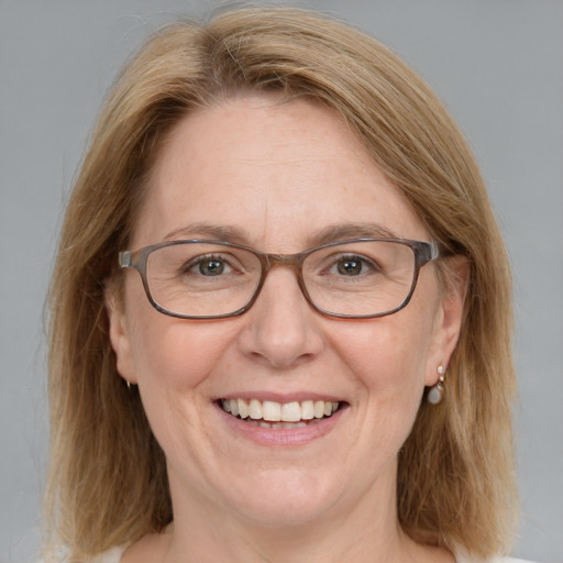 Joyful white adult female with medium  brown hair and blue eyes