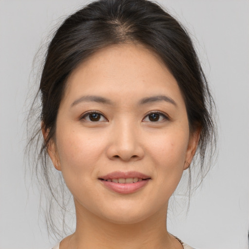 Joyful asian young-adult female with medium  brown hair and brown eyes