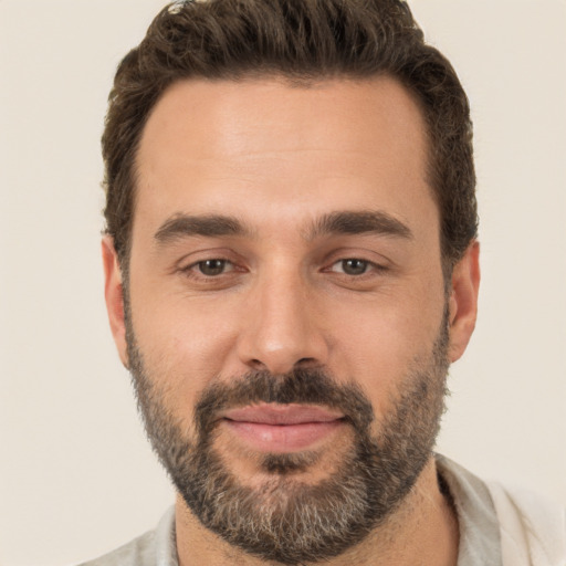 Joyful white adult male with short  brown hair and brown eyes