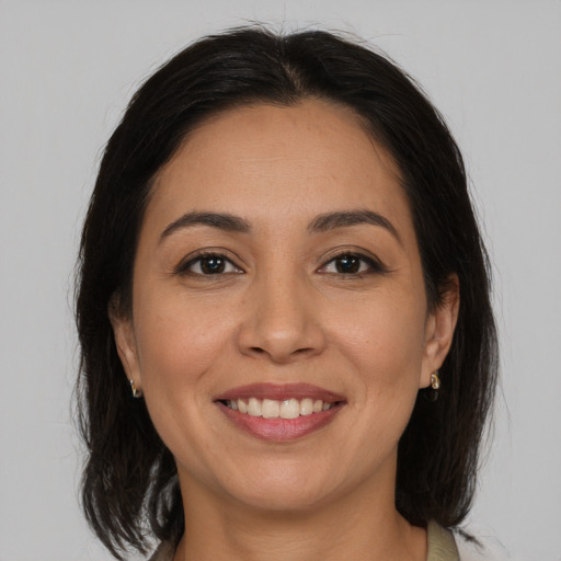 Joyful white adult female with medium  brown hair and brown eyes