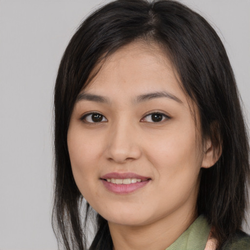 Joyful asian young-adult female with long  brown hair and brown eyes