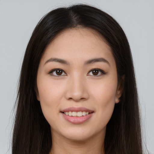 Joyful asian young-adult female with long  brown hair and brown eyes
