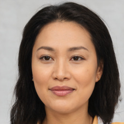 Joyful asian young-adult female with medium  brown hair and brown eyes