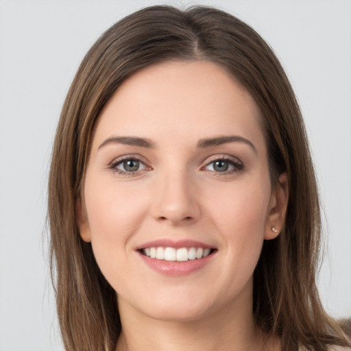 Joyful white young-adult female with long  brown hair and grey eyes